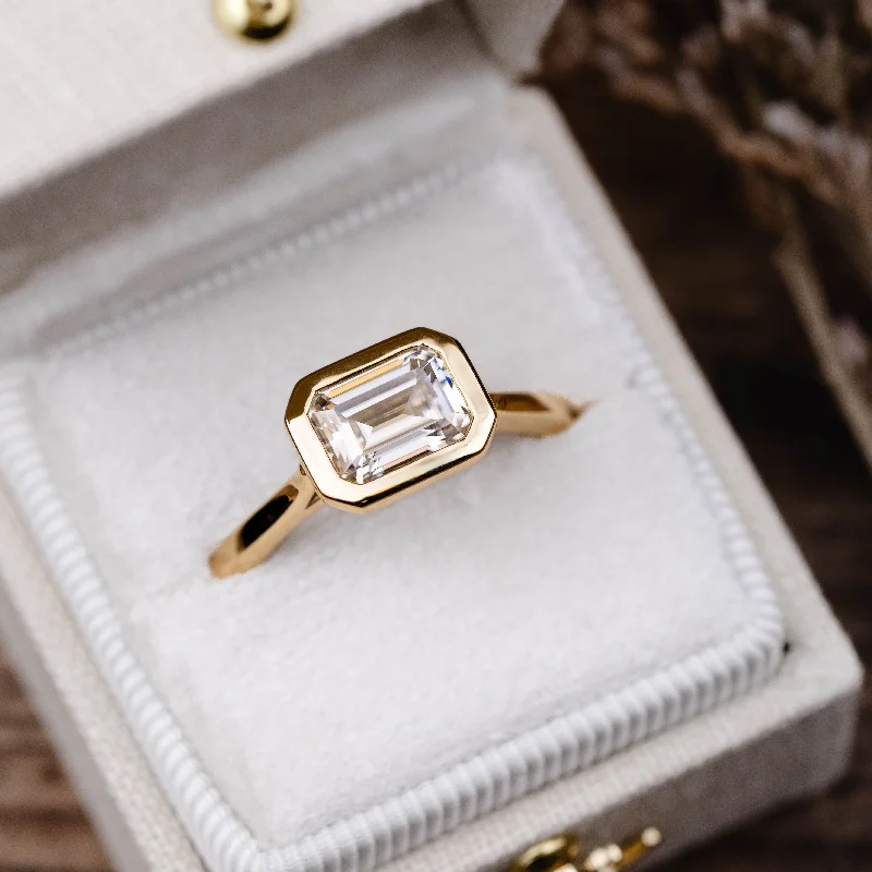 Cluster Engagement Rings with Multiple Small Diamonds Arranged in a Stunning DesignThe Adeline - Hidden Halo Emerald Cut Moissanite Engagement Ring with Bezel Setting